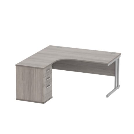 Double upright left hand radial desk in Alaskan Grey Oak with silver finish, featuring a 600mm deep desk high pedestal.