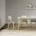 FJORD Chair with a polypropylene shell and wooden legs, featuring a light pink seat in a modern café setting.