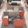 Modular Oasis Screens in orange and gray create private work zones with desks in an open-plan office space.