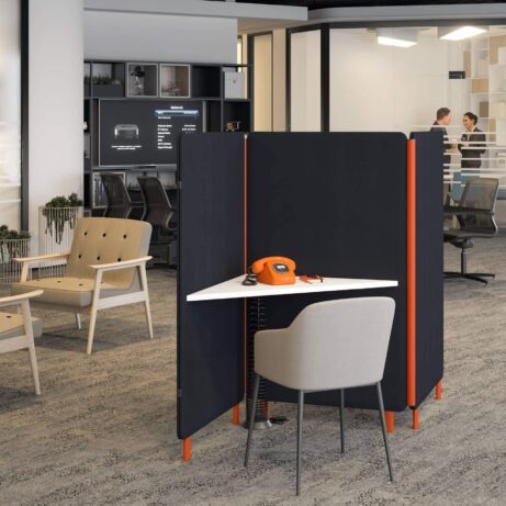 Oasis Floor Standing Screen in black with orange accents creates a private work zone for a desk and chair in an office setting.