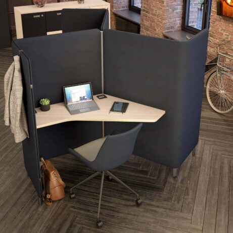 Oasis Floor Standing Screen in navy, creating a private work zone with a desk and ergonomic chair in an open-plan office.