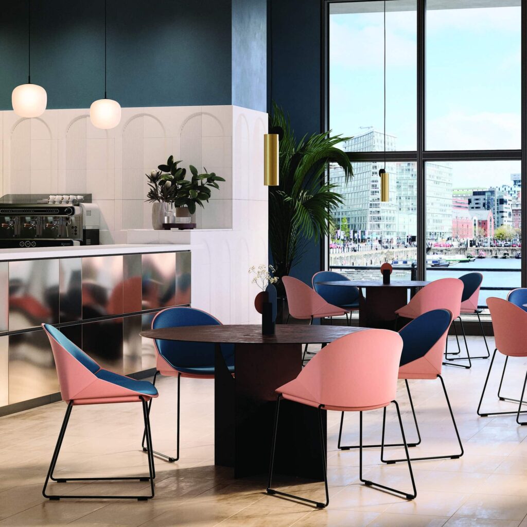 Papillon Meeting & Café Chairs in pink and blue shells, set around a table in a modern café space with large windows.