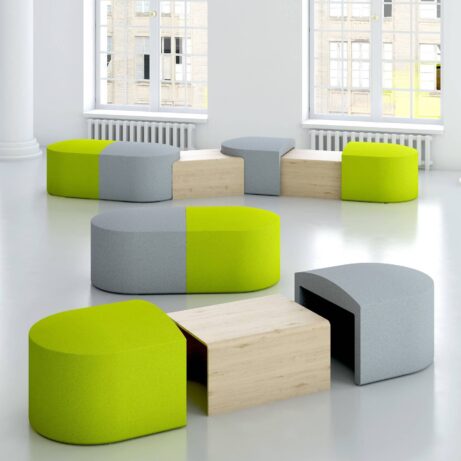 Modular PILL seating in gray and lime green, featuring integrated tables, arranged for flexible breakout spaces.