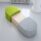 Modular PILL seating in green and gray with concealed table, designed for flexible breakout or reception spaces.