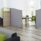 Freestanding floor standing system screens in grey with acrylic tops, providing privacy in an open-plan office space.