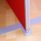 Floor Standing System Screen with a red fabric finish and a gray metal base, designed for privacy in open-plan offices.