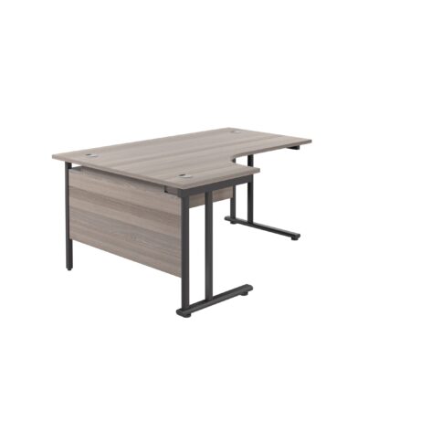 Twin upright left hand radial desk with grey oak top and black frame, dimensions 1800 x 1200 mm.