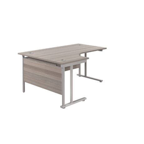 Twin Upright Left Hand Radial Desk, grey oak top, silver frame, dimensions 1800 x 1200 mm. FSC certified.