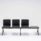 Modular SHILA Beam seating in black, featuring three seats and one side table, ideal for reception and waiting areas.