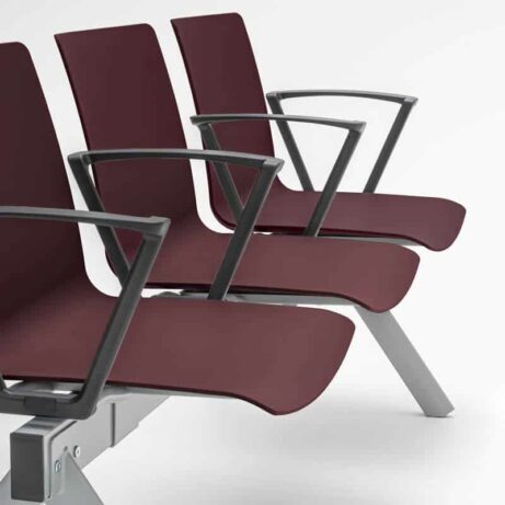 SHILA Beam seating in burgundy upholstery with silver armrests, designed for reception and waiting areas. Modular design.